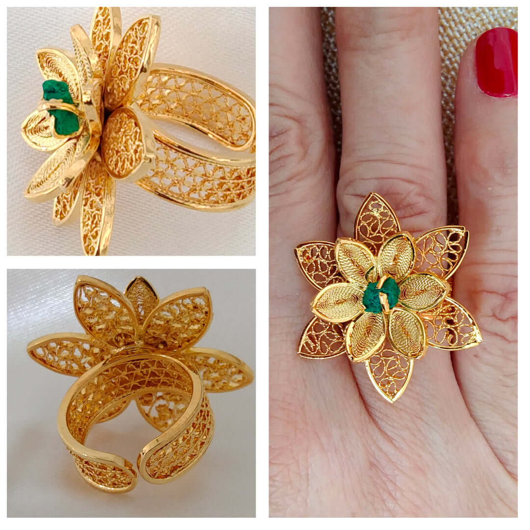 Ladies ring in the shape of a flower with an emerald cut filigree